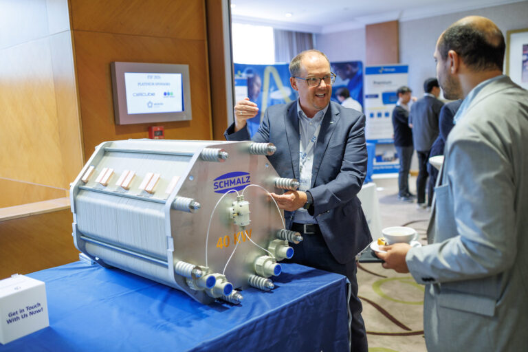 Technical discussion at an exhibitor stand during the International Flow Battery Forum 2026